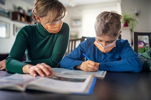 Image of an adult and child wearing facemasks